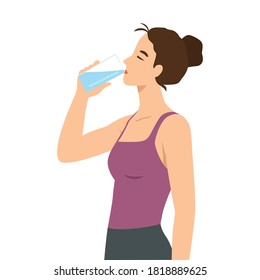 Attractive young woman is drinking water from a plastic bottle. Fitness and health.