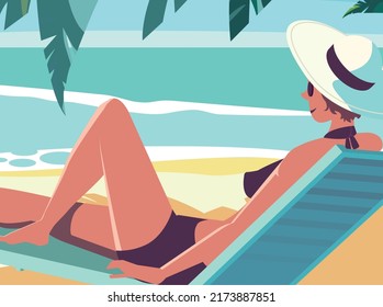 An attractive young woman wearing a black bikini sits on a beach. Beautiful landscape with girl in the white hat and leaves of the palm, with view on the beach and ocean.