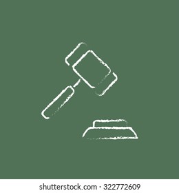 Auction gavel hand drawn in chalk on a blackboard vector white icon isolated on a green background.