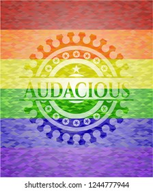 Audacious on mosaic background with the colors of the LGBT flag