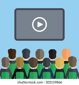 Audience with presentation. Many people on the seats in front of the screen with play icon.