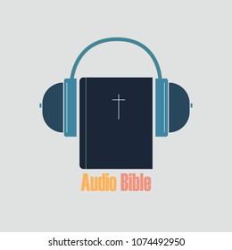 Audio Bible for listening on electronic media in headphones. Bible and audio headphones on a white background.
