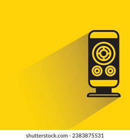 audio loudspeaker with shadow on yellow background