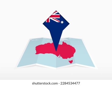 Australia is depicted on a folded paper map and pinned location marker with flag of Australia. Folded vector map.