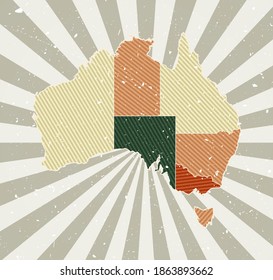 Australia vintage map. Grunge poster with map of the country in retro color palette. Shape of Australia with sunburst rays background. Vector illustration.