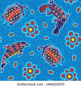 Australian aboriginal art seamless vector pattern with colorful dolphin, turtle, platypus and other typical elements on dotted background or texture