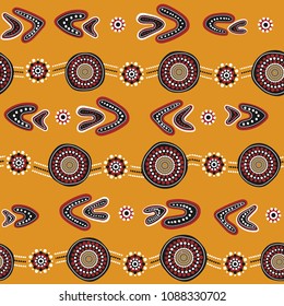 Australian aboriginal seamless vector pattern with colorful dotted circles, rings, boomerangs and wavy stripes on yellow background