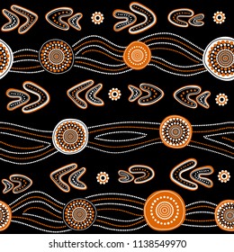 Australian aboriginal seamless vector pattern with white and orange dotted circles, rings, boomerangs and wavy stripes on black background