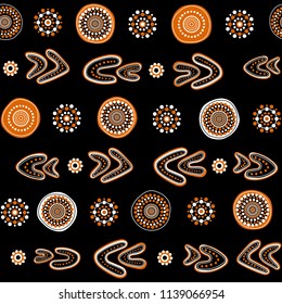 Australian aboriginal seamless vector pattern with white and orange dotted circles, rings and boomerangs on black background