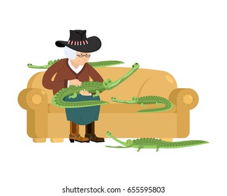 Australian grandmother and crocodile. Australia old woman and an alligator pet. grandma in hat on sofa. Crocodile farm. gammer breeds wild reptiles and predators