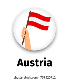 Austria flag in hand, round icon with shadow isolated on white. Human hand holding flag, vecctor illustration