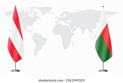 Austria and Madagascar flags for official meeting against background of world map.