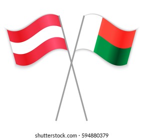 Austrian and Malagasy crossed flags. Austria combined with Madagascar isolated on white. Language learning, international business or travel concept.