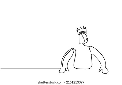 authoritative successful male in a king's crown puts his hand on the table and looks