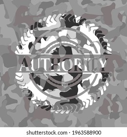 Authority written on a grey camouflage texture 
