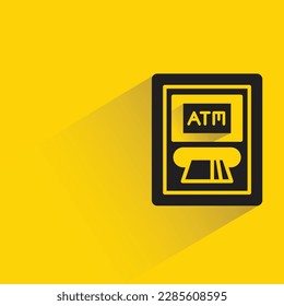 automated teller machine with shadow on yellow background