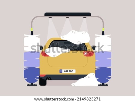 Automatic carwash service with huge brushes and water shower, rear view