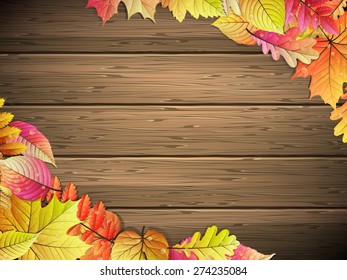 Autumn background with colored leaves on wooden board. EPS 10 vector file included