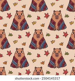 Autumn background with cozy animal capybara wrapped in comfy blanket. Seamless pattern with cartoon character and fall leaves. Vector illustration isolated on beige background