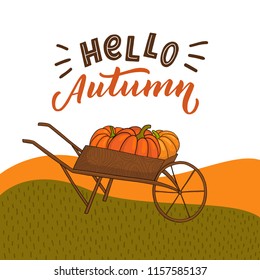 Autumn background with grass field with pumpkins on truck and hand drawn lettering hello autumn.