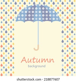 Autumn background with umbrella and raindrops