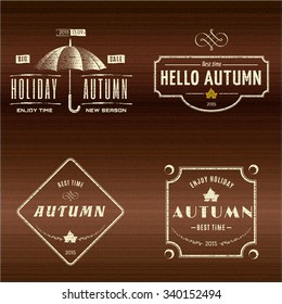 Autumn badges logos and labels can be used to design packages of goods during autumn sales on a wooden background