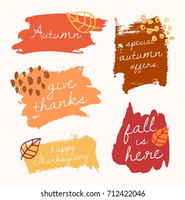 Autumn brush stroke banners with text in yellow, red, brown and orange isolated on white background.
