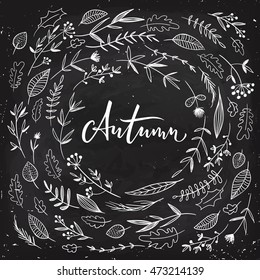 Autumn calligraphy with flowers and leaves on dark background. Autumn card. Hand drawn elements. Blackboard design. 