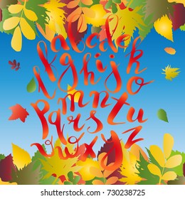 Autumn calligraphy. Unique vector alphabet. Lettering design. Autumn letters on blue background with border from leaves. Hipster letters. Fall.