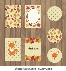 Autumn cards set. Seven different shapes of cards with colored pictures of autumn nature. Leaf pattern, fox figure, autumn and photo frame. Cards with seamless autumn patterns on wooden background.