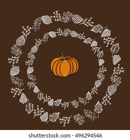 Autumn circular composition. Halloween background. fir branches, acorn, cones and leaves defoliation, maple, oak pattern. brawn background. mid pumpkin