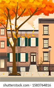 Autumn city with a leaf fall. Houses on the street along the road.