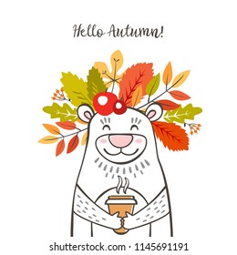 autumn cute bear with a wreath of autumn leaves on his head and a cup of coffee in his hands