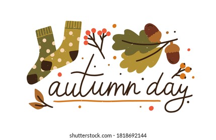 Autumn day colorful lettering with design elements vector flat illustration. Cute fall composition decorated by leaves, acorn, branches, berries and warm socks isolated. Cozy seasonal inscription