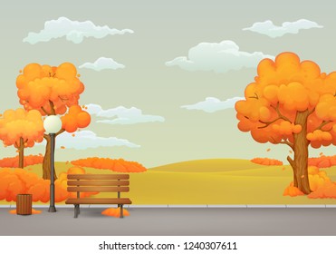 Autumn day park scene. Wooden bench with trash can and street lamp on the park trail with orange trees and bushes with falling leaves. Withered meadow and gray sky with clouds on the background.