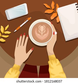 Autumn flat lay with the girl sitting at a table in a cafe with a Cup of cappuccino. Notebook, pen, smartphone, autumn leaves.