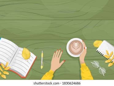 Autumn flat lay with the girl sitting at a table in a cafe with a Cup of cappuccino. Notebook, pen and autumn leaves.