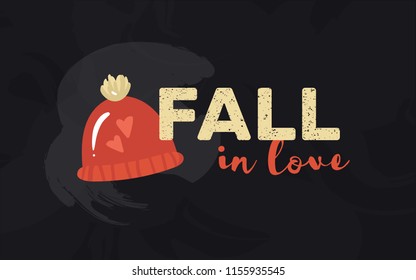 Autumn horisontal card with the wordplay "fall in love" and warm knitted hat with pompon and two hearts. Fall colored vector illustration on blackboard background for poster or banner