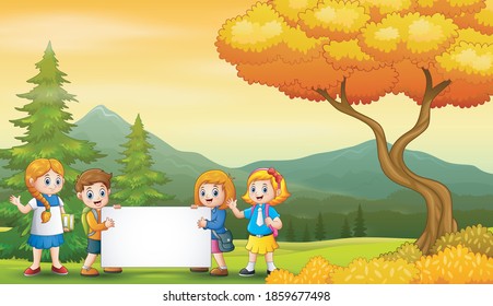 Autumn landscape with school kids holding blank sign