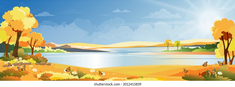 Autumn landscape at village by the river with grass land and mountain with blue sky and clouds, Vector Cartoon Autumnal Panoramic countryside by the lake with sunrise,Fall season background 