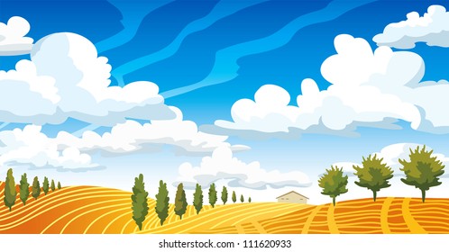 Autumn landscape with yellow meadow and green trees on a blue cloudy sky