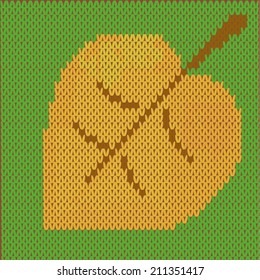 autumn leaf on a knitted surface