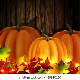 autumn leaves cozy patio lights and three orange pumpkins on wooden texture