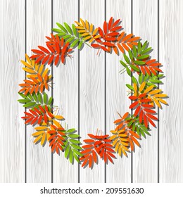 Autumn leaves frame on white wooden background