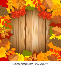 Autumn leaves frame on wood background