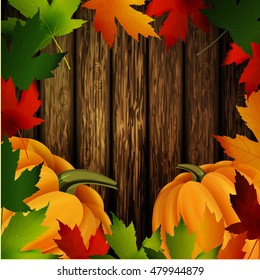 Autumn leaves frame and pumpkins on wooden texture