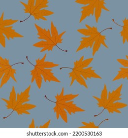 Autumn leaves on a blue background. Seamless pattern.