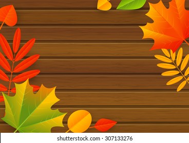 Autumn leaves on wooden background