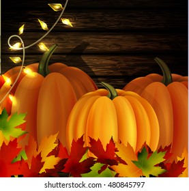 Autumn leaves and pumpkins on wooden texture