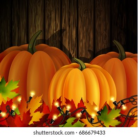 Autumn leaves and pumpkins on wooden texture